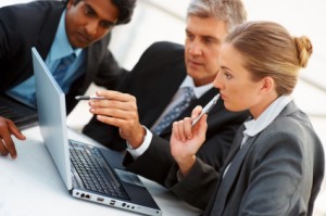 iStock_000010827673XSmall Team of business people working together on a laptop